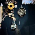 Black cosmic*flower ear cuff