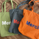 "merci"プリントトートバッグ（オレンジ）