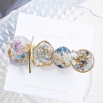 ブルーの変形楕円とジルコニアのレジンヘアクリップ