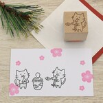 火吹き龍をだっこしてお餅を焼く 猫のはんこ