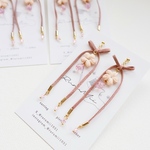 揺れるリボンの耳飾り(ピンク)