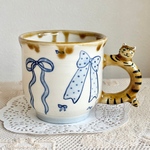 リボンと茶トラねこのマグカップ　陶器　磁器　リボン柄　白　青　ブルー　ブラウン　茶色　飴色　大きめマグカップ　大きなマグ　茶トラネコ　マグカップ　おうちカフェ　おうち時間　コーヒータイム　おやつタイム