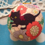 マカロンケースのストラップ　(お花の中から黒猫さん　ピンク)