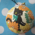 マカロンケースのストラップ　(お花の中から黒猫さん　水色)
