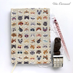 刺繍入りメガネをかけた猫いっぱい布張りB6ノート・ベージュ＆茶トラ