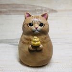 💩を持つ茶トラねっこの置物